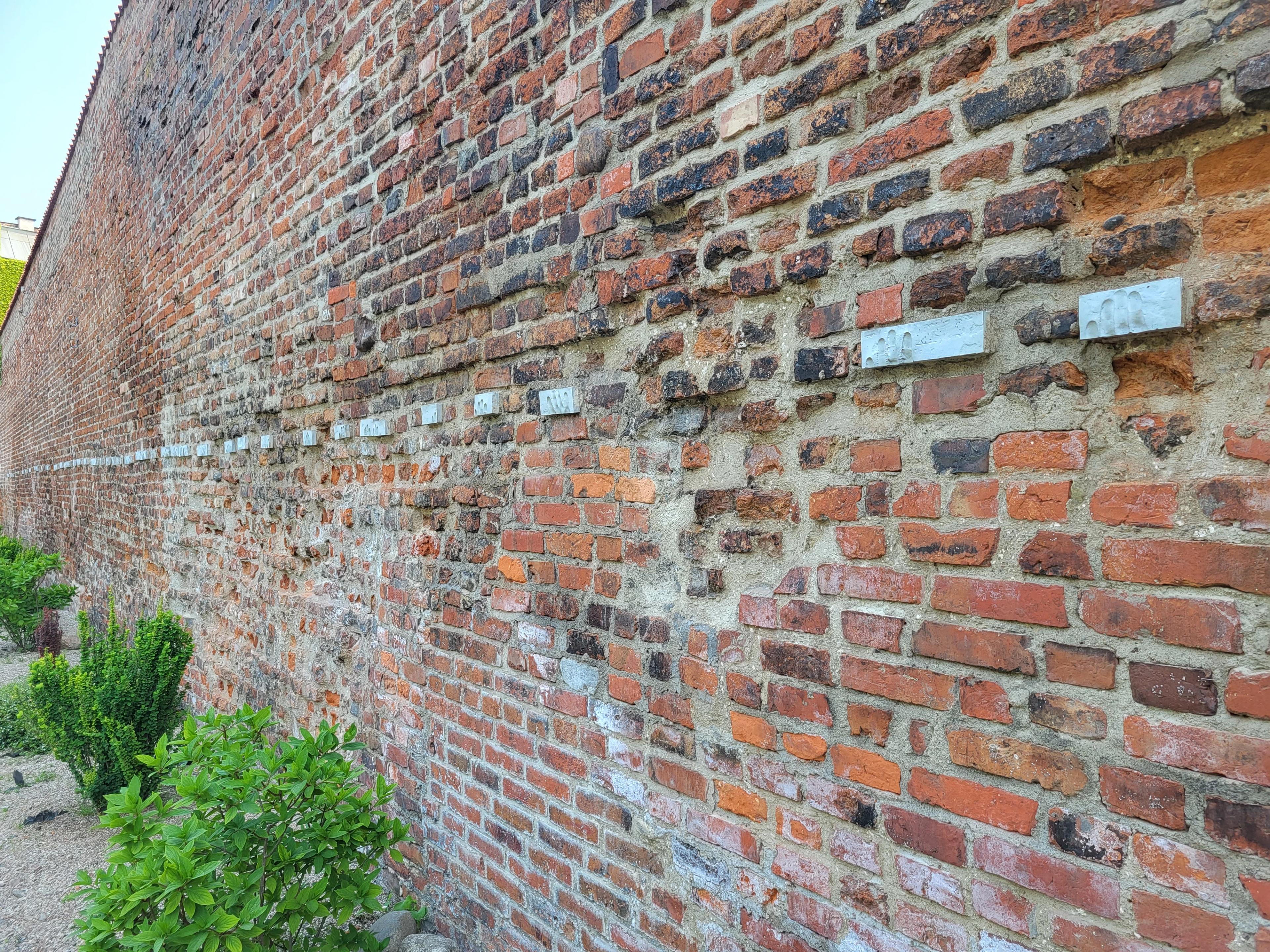 Wall by the post office with symbolic imprints of executed postal workers 3