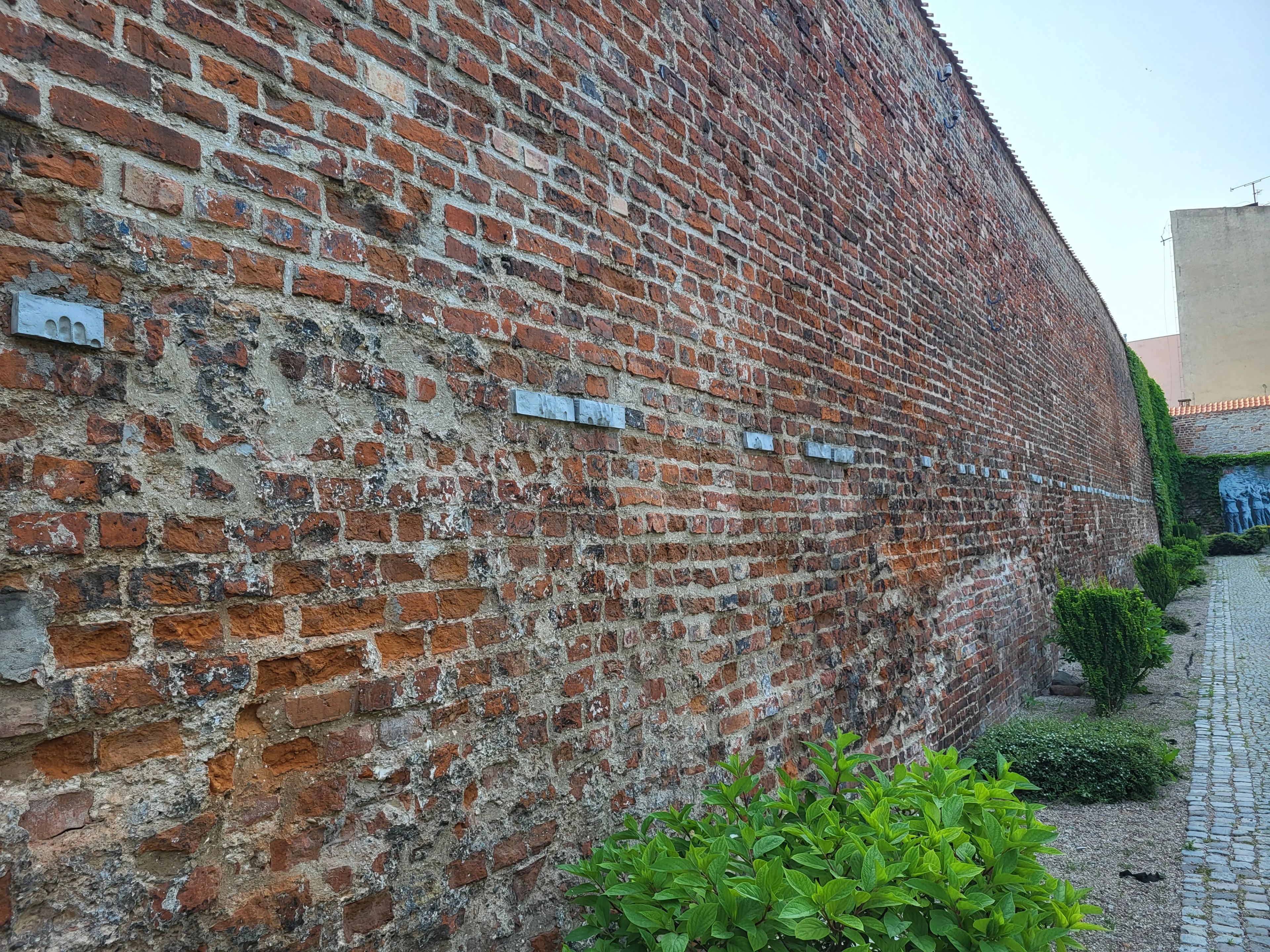 Wall by the post office with symbolic imprints of executed postal workers 4