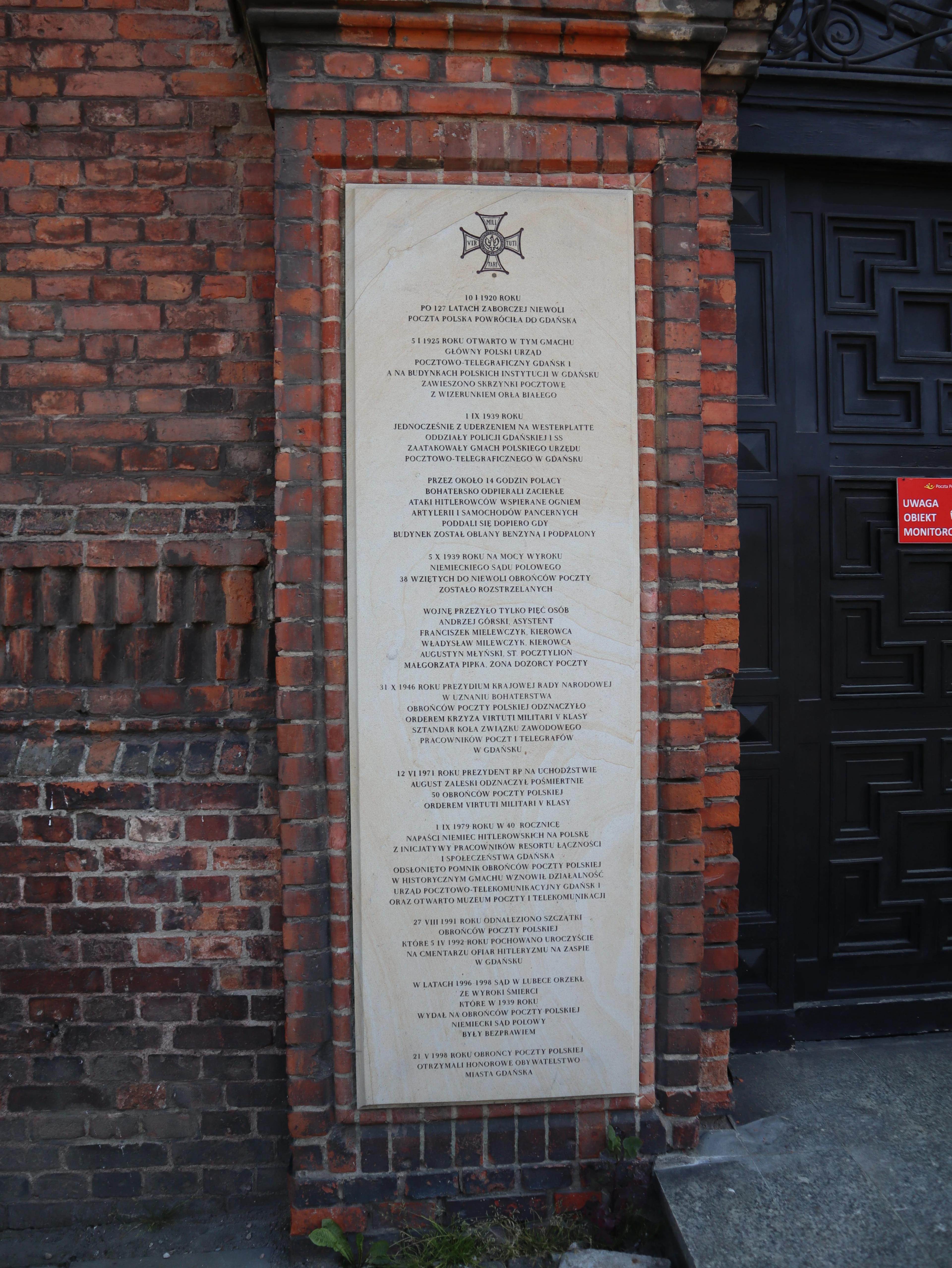 Board on the left at the entrance to the Polish Post Office building