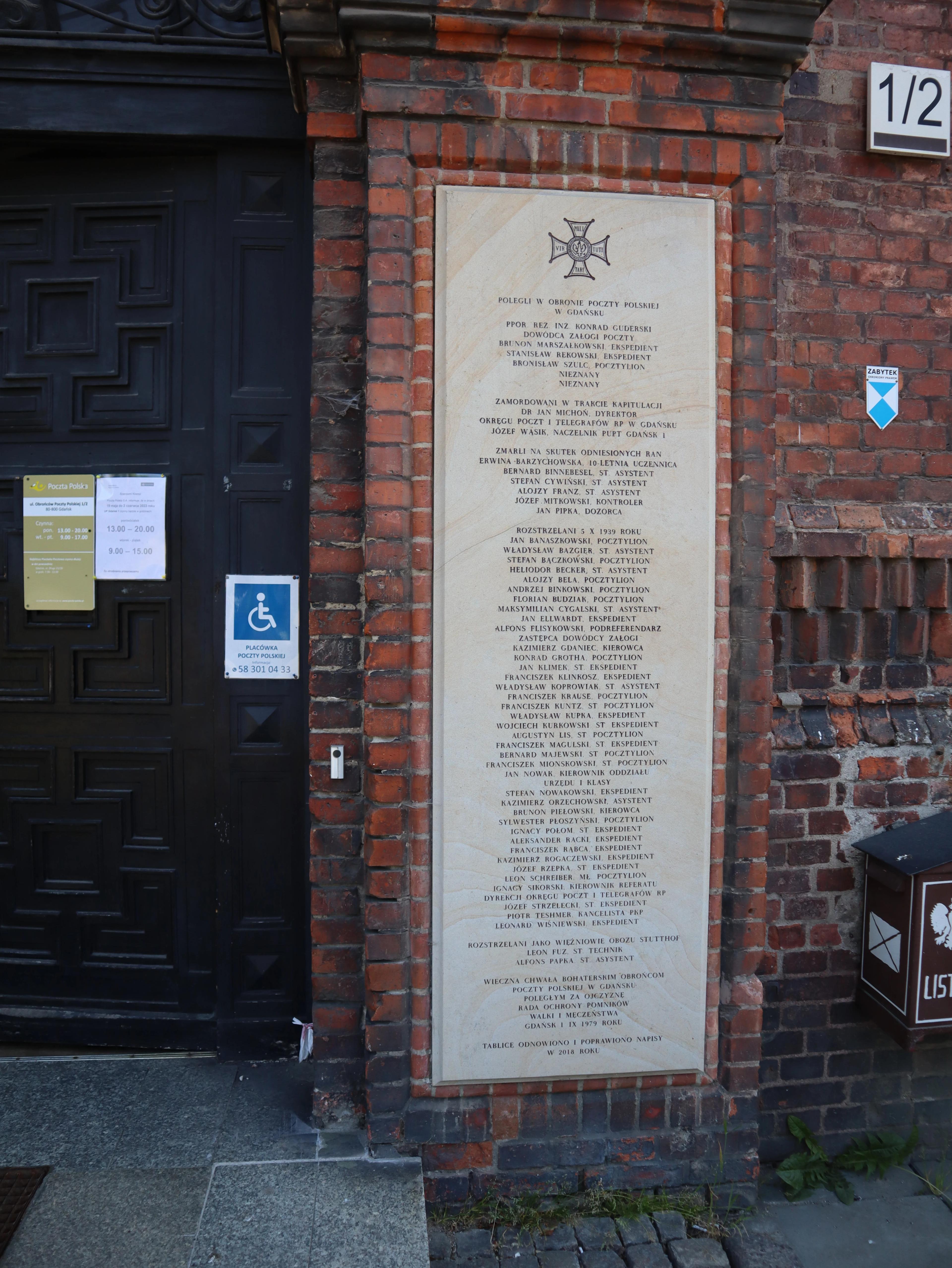 Board on the right at the entrance to the Polish Post Office building