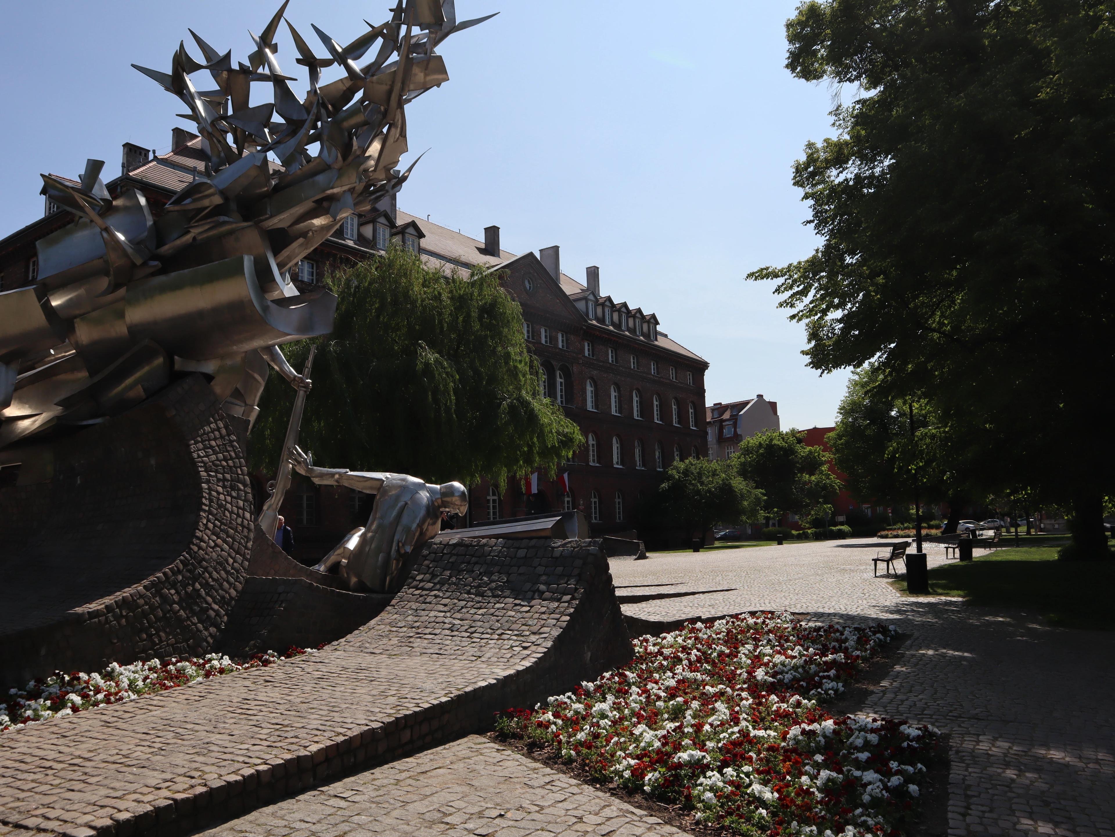 Monument to the Defenders of the Polish Post Office with the Polish Post Office building in the background